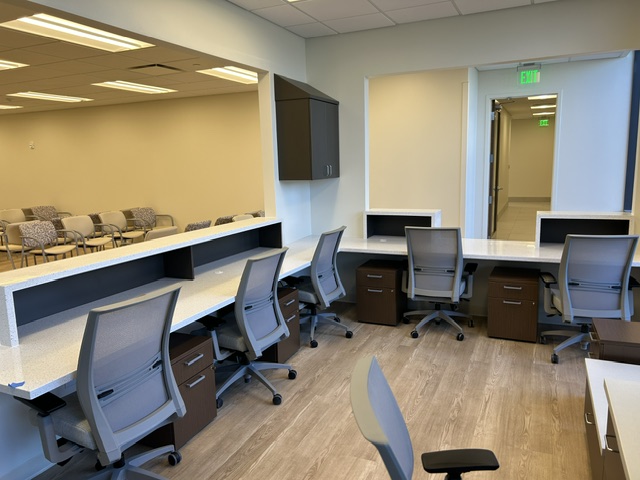 Interior view of a pediatric rehab office with multiple desks and chairs, designed for administrative tasks.